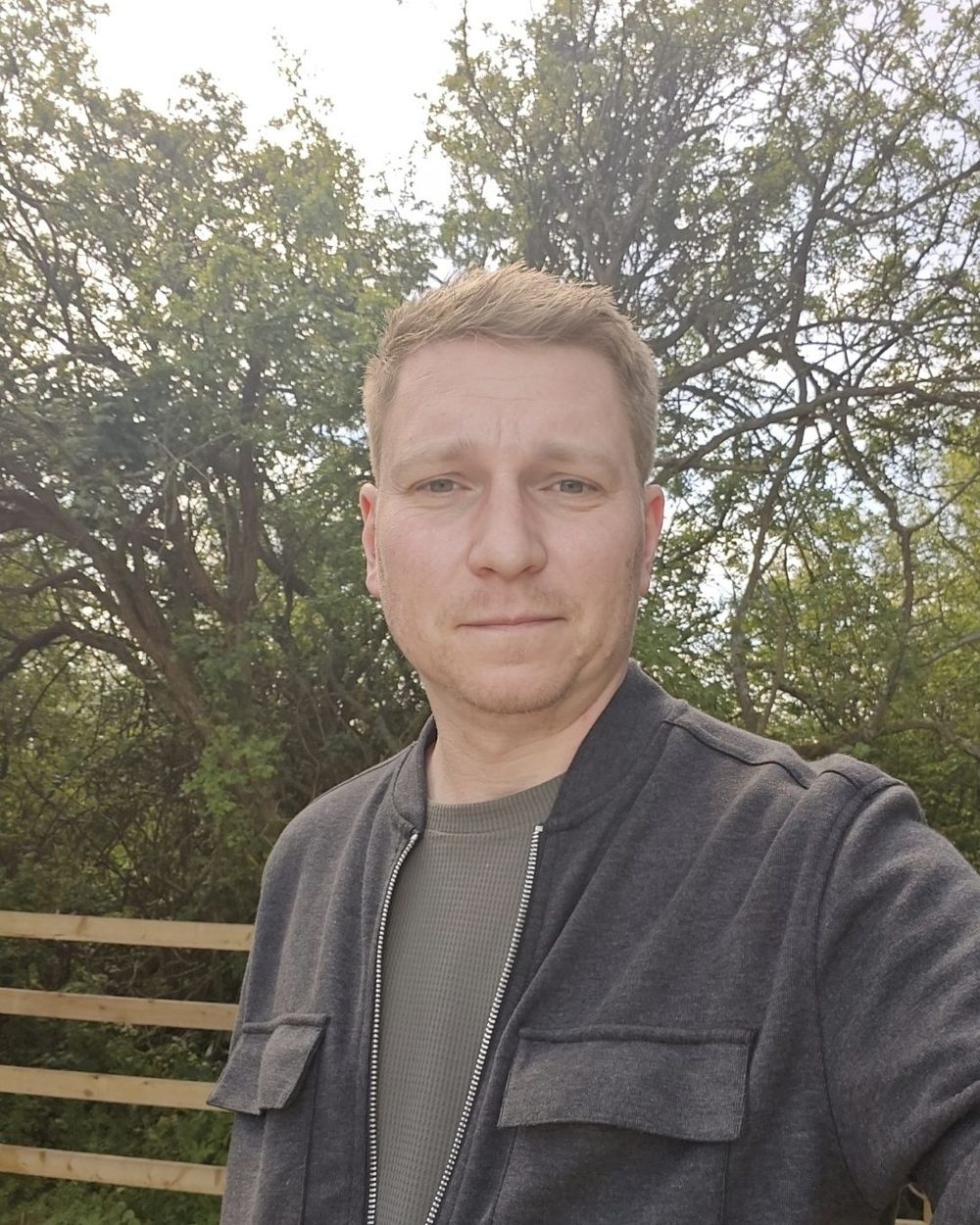 Sam, your Spanish teacher in Basildon, outside in front of trees